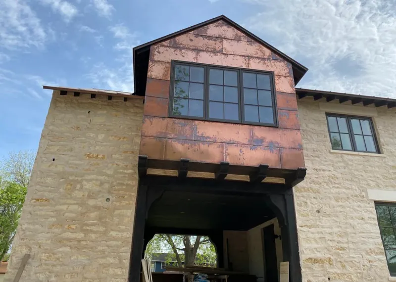 Copper metal panel facade on a stone building for Skylight Installation in Sherwood